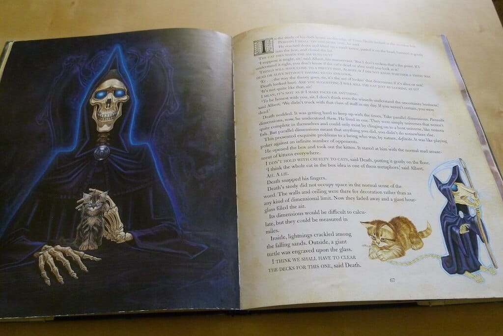 Open book: Left page with a full-page colorful illustration of Death and a kitten, with story text on the right. In the lower right corner, another kitten plays with a tiny Death of Rats
