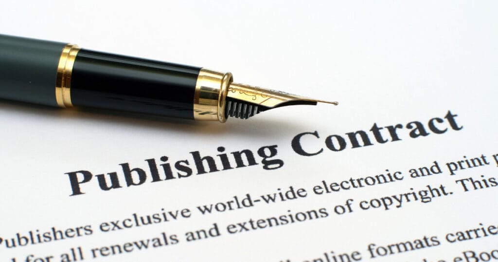 book designer - publishing contract and fountain pin.