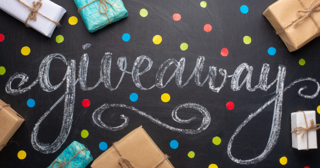 book giveaways - board with confetti, gifts and the word giveaway