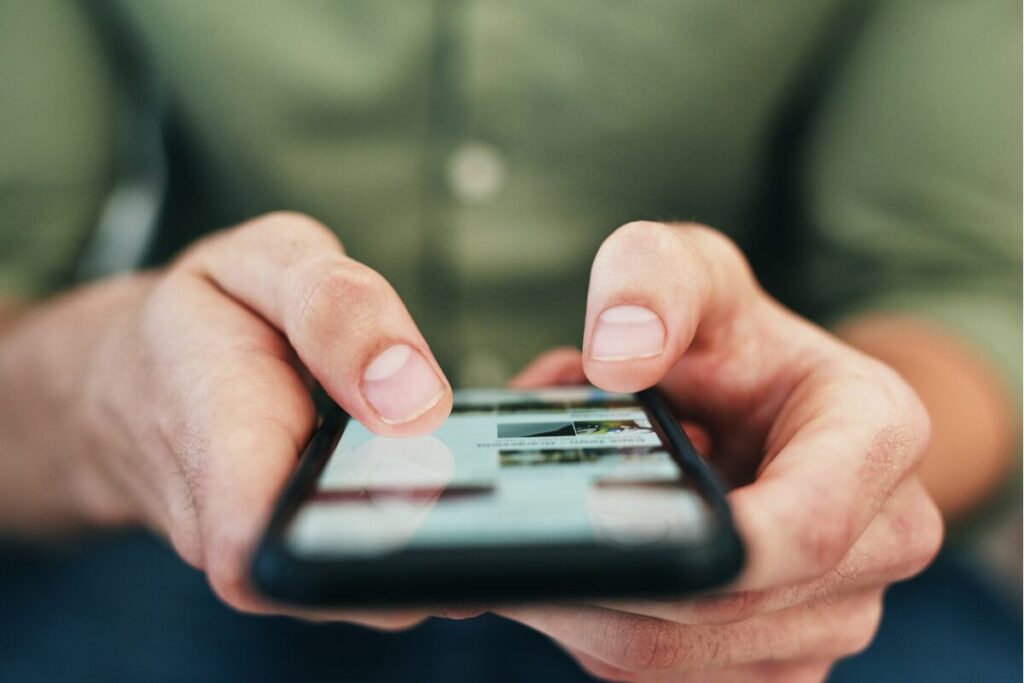 social media - image of person using social media on his phone. 